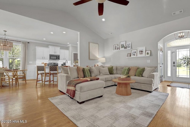 127 Azalea Dr, Hampstead, NC 28443 - living area with a chandelier, light wood-style flooring, vaulted ceiling, ceiling fan, and arched walkways