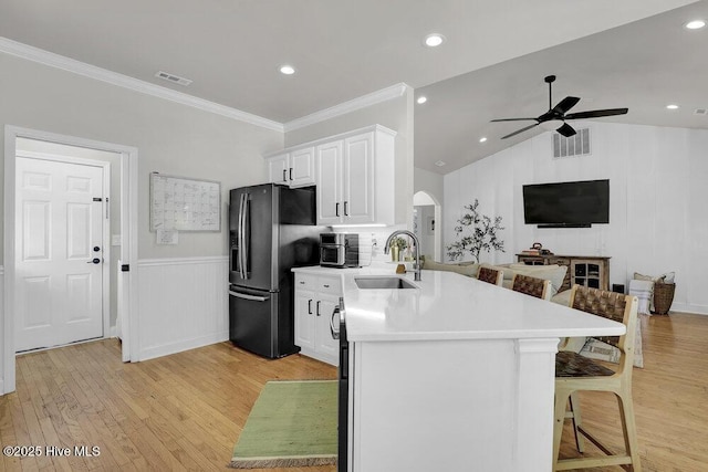 127 Azalea Dr, Hampstead, NC 28443 - kitchen with a sink, stainless steel fridge, a peninsula, a ceiling fan, and a breakfast bar area