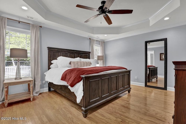 127 Azalea Dr, Hampstead, NC 28443 - bedroom with ornamental molding, light wood-style flooring, multiple windows, a raised ceiling, and baseboards