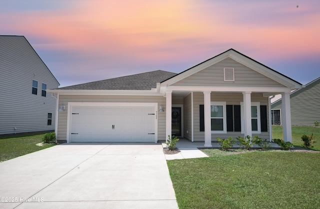 9308 Little Osprey Dr, Calabash, NC 28467 - ranch-style house with a porch, driveway, a garage, and a yard