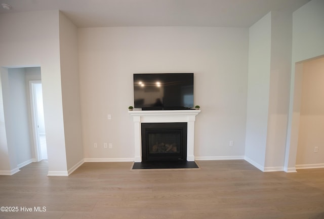 9308 Little Osprey Dr, Calabash, NC 28467 - unfurnished living room featuring wood finished floors and a fireplace with flush hearth