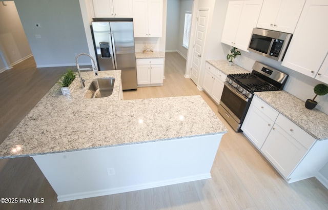 9308 Little Osprey Dr, Calabash, NC 28467 - kitchen with appliances with stainless steel finishes, light wood-type flooring, and white cabinets