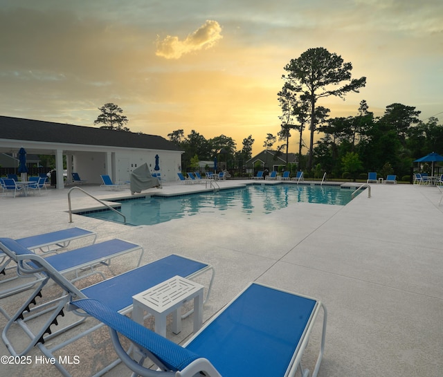 9308 Little Osprey Dr, Calabash, NC 28467 - pool at dusk featuring a patio and a community pool