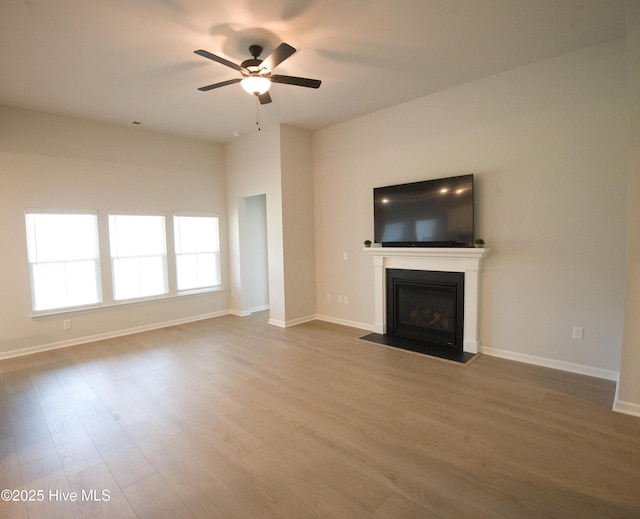 9308 Little Osprey Dr, Calabash, NC 28467 - unfurnished living room with ceiling fan, a fireplace with flush hearth, and wood finished floors