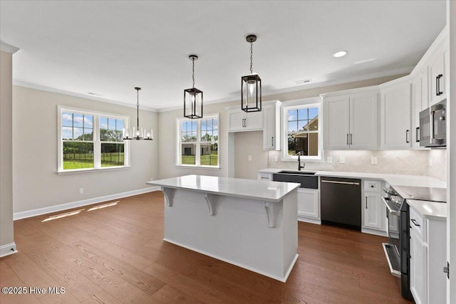 2190 Heartland Rd, Battleboro, NC 27809 - kitchen featuring dishwashing machine, a sink, range with electric stovetop, stainless steel microwave, and white cabinets