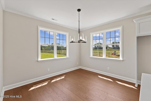2190 Heartland Rd, Battleboro, NC 27809 - unfurnished dining area with baseboards, a chandelier, wood finished floors, and crown molding