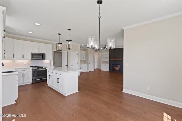 2190 Heartland Rd, Battleboro, NC 27809 - kitchen featuring stainless steel microwave, electric stove, crown molding, light countertops, and dark wood-type flooring