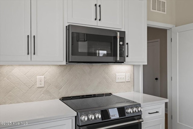 2190 Heartland Rd, Battleboro, NC 27809 - kitchen featuring electric range, white cabinetry, light countertops, and tasteful backsplash