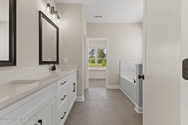 2190 Heartland Rd, Battleboro, NC 27809 - bathroom featuring double vanity, a bath, and baseboards