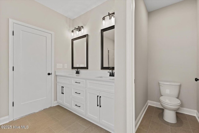 2190 Heartland Rd, Battleboro, NC 27809 - full bathroom featuring double vanity, tile patterned floors, baseboards, and toilet