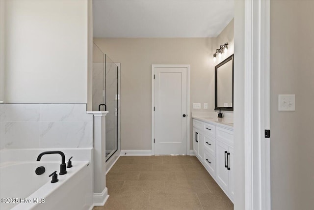 2190 Heartland Rd, Battleboro, NC 27809 - bathroom with vanity, a garden tub, a stall shower, and baseboards
