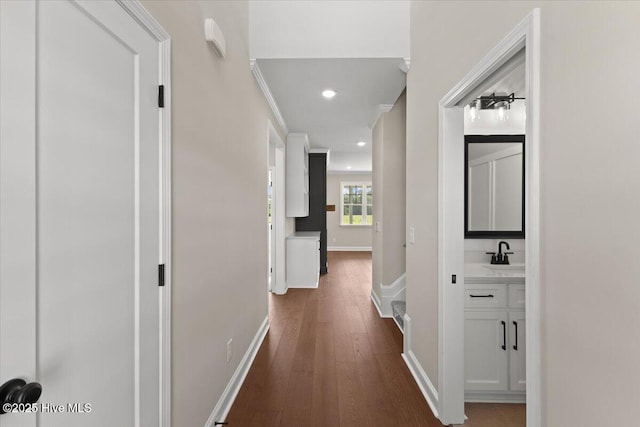2190 Heartland Rd, Battleboro, NC 27809 - hallway with dark wood-style floors, recessed lighting, baseboards, and a sink