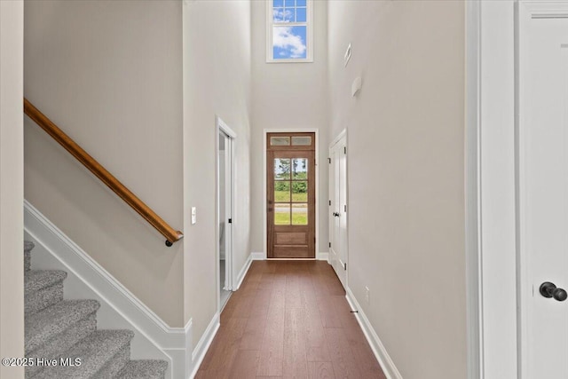 2190 Heartland Rd, Battleboro, NC 27809 - entrance foyer with dark wood-style flooring, stairs, baseboards, and a towering ceiling