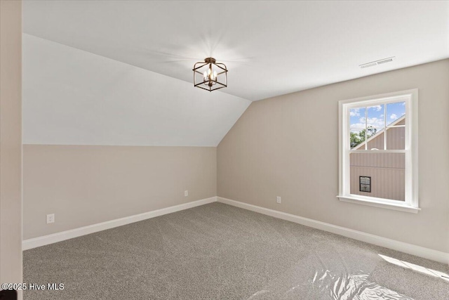 2190 Heartland Rd, Battleboro, NC 27809 - bonus room featuring vaulted ceiling, baseboards, carpet, and a chandelier