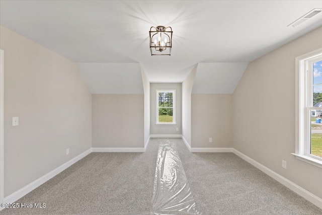 2190 Heartland Rd, Battleboro, NC 27809 - additional living space featuring vaulted ceiling, carpet, healthy amount of natural light, a chandelier, and baseboards