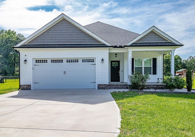 1707 N Carolina St, Goldsboro, NC 27530 - view of front of home with driveway, an attached garage, a front lawn, and covered porch