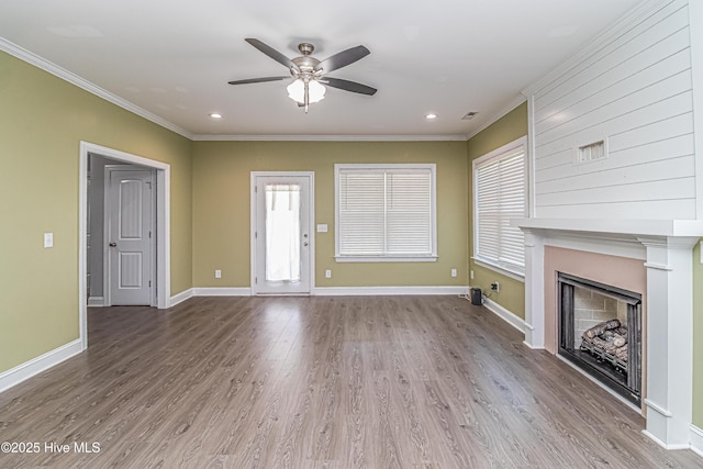 1707 N Carolina St, Goldsboro, NC 27530 - unfurnished living room featuring ornamental molding, a ceiling fan, wood finished floors, a fireplace, and baseboards