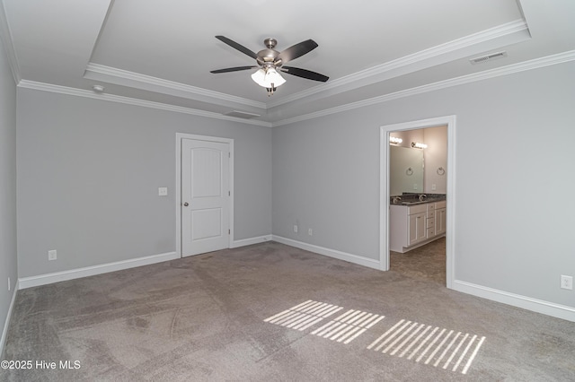 1707 N Carolina St, Goldsboro, NC 27530 - carpeted spare room featuring a tray ceiling, a ceiling fan, ornamental molding, and baseboards