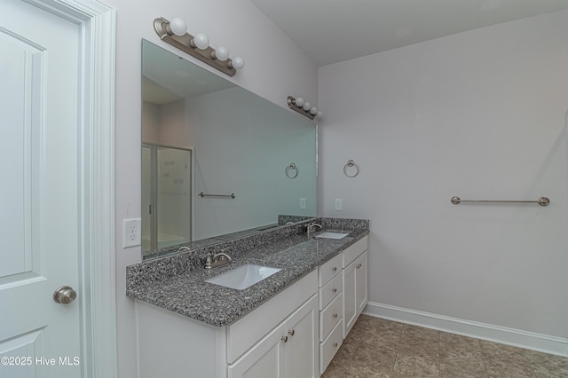 1707 N Carolina St, Goldsboro, NC 27530 - bathroom with double vanity, a shower with shower door, and baseboards