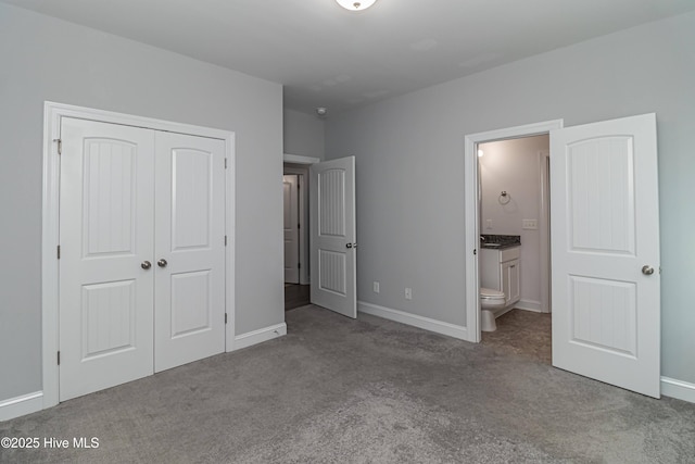 1707 N Carolina St, Goldsboro, NC 27530 - unfurnished bedroom featuring carpet, a closet, connected bathroom, and baseboards