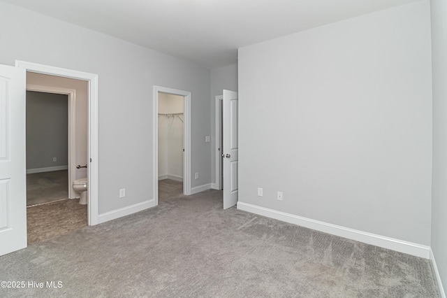 1707 N Carolina St, Goldsboro, NC 27530 - unfurnished bedroom featuring carpet, a spacious closet, baseboards, and a closet