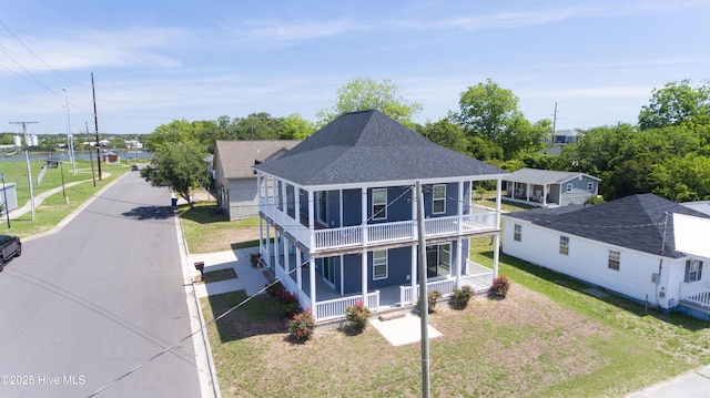 302 N 16th St, Morehead City, NC 28557 - view of front of home featuring covered porch, a balcony, a shingled roof, and a front yard