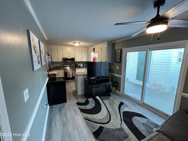 920 Spring Forest Rd Unit L-5, Greenville, NC 27834 - kitchen with appliances with stainless steel finishes, light wood finished floors, white cabinetry, crown molding, and a peninsula