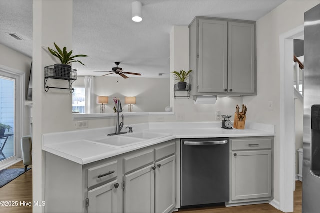 5109 Gate Post Ln, Wilmington, NC 28412 - kitchen featuring stainless steel dishwasher, gray cabinetry, a sink, a textured ceiling, and ceiling fan