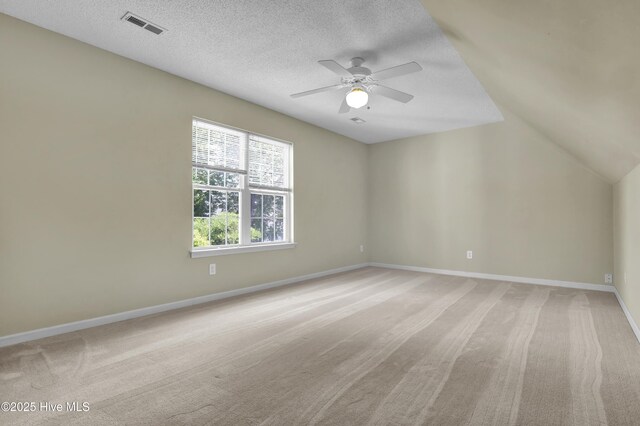 5109 Gate Post Ln, Wilmington, NC 28412 - additional living space featuring a ceiling fan, light carpet, a textured ceiling, baseboards, and vaulted ceiling