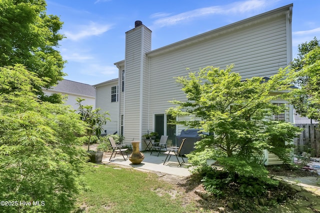 5109 Gate Post Ln, Wilmington, NC 28412 - back of house with a patio area and a chimney