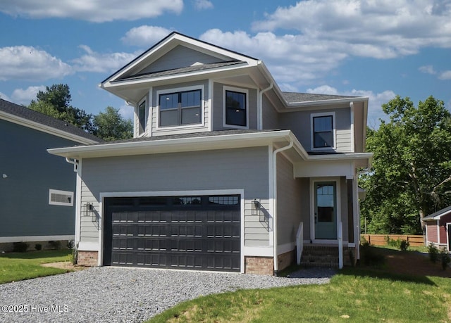 472 Yadkin Rd, Southern Pines, NC 28387 - view of front facade featuring a garage, gravel driveway, entry steps, and a front yard