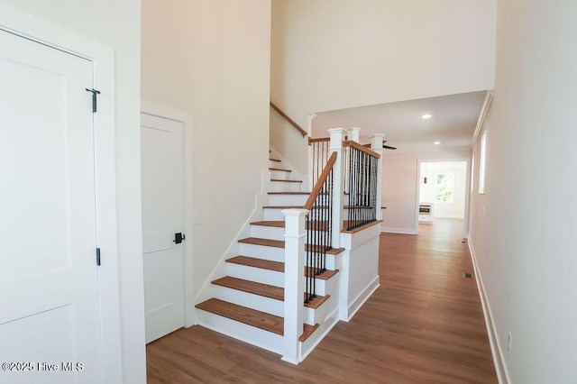 472 Yadkin Rd, Southern Pines, NC 28387 - stairs with wood finished floors, baseboards, a high ceiling, and recessed lighting