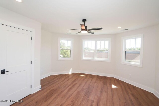 472 Yadkin Rd, Southern Pines, NC 28387 - unfurnished room with plenty of natural light, a ceiling fan, baseboards, recessed lighting, and wood finished floors