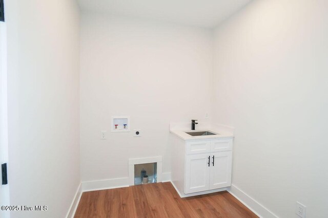 472 Yadkin Rd, Southern Pines, NC 28387 - laundry room featuring hookup for a washing machine, hookup for an electric dryer, light wood-type flooring, baseboards, and cabinet space