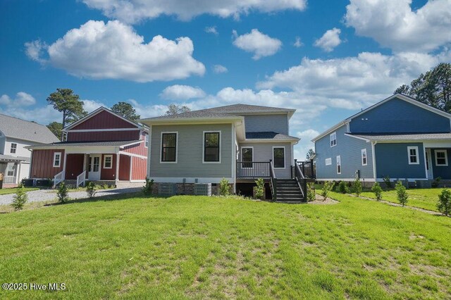 472 Yadkin Rd, Southern Pines, NC 28387 - rear view of house with a lawn, covered porch, and a wooden deck