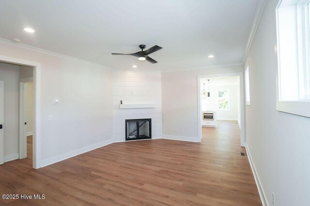 472 Yadkin Rd, Southern Pines, NC 28387 - unfurnished living room with ornamental molding, light wood-style flooring, a ceiling fan, healthy amount of natural light, and recessed lighting