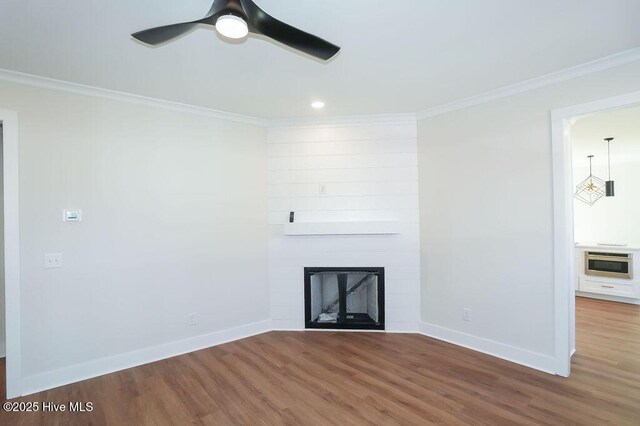 472 Yadkin Rd, Southern Pines, NC 28387 - unfurnished living room with wood finished floors, ornamental molding, baseboards, a fireplace, and ceiling fan