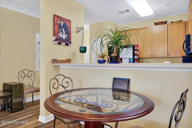 250 S Crow Creek Dr NW Unit 1, Calabash, NC 28467 - dining area view of wood finished floors, baseboards, and black microwave