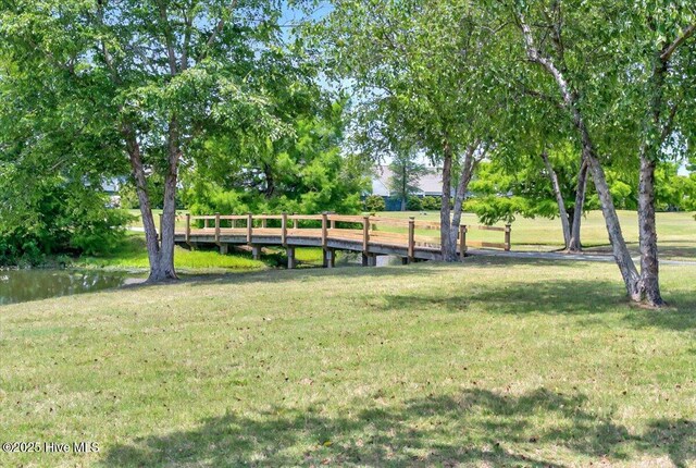 250 S Crow Creek Dr NW Unit 1, Calabash, NC 28467 - surrounding community with a yard and a water view