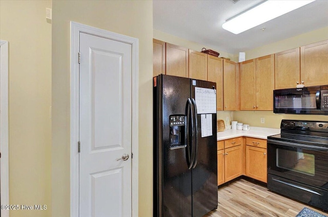 250 S Crow Creek Dr NW Unit 1, Calabash, NC 28467 - kitchen featuring black appliances, light wood-style floors, light countertops, and light brown cabinets