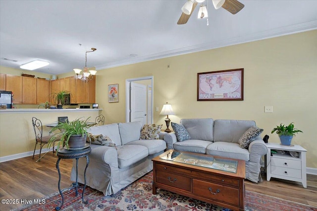250 S Crow Creek Dr NW Unit 1, Calabash, NC 28467 - living area with wood finished floors, ornamental molding, ceiling fan, baseboards, and a chandelier