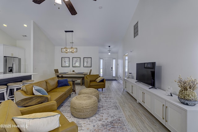 302 Gaskins Ln, Wilmington, NC 28411 - living room featuring a ceiling fan, high vaulted ceiling, light wood-style flooring, a chandelier, and recessed lighting