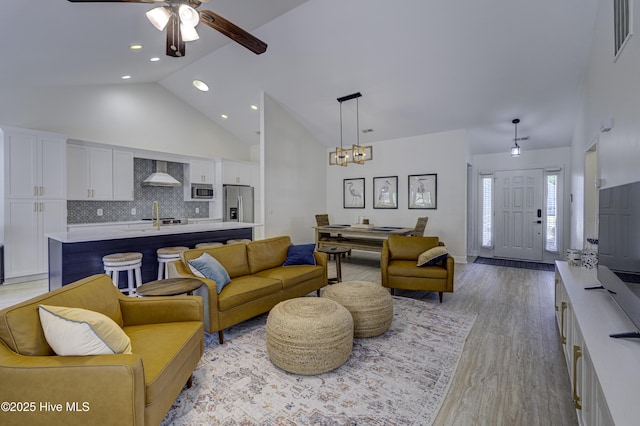 302 Gaskins Ln, Wilmington, NC 28411 - living area with high vaulted ceiling, light wood-type flooring, ceiling fan, recessed lighting, and a chandelier