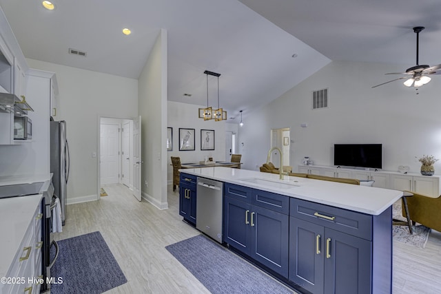 302 Gaskins Ln, Wilmington, NC 28411 - kitchen with stainless steel appliances, a sink, open floor plan, blue cabinetry, and light countertops