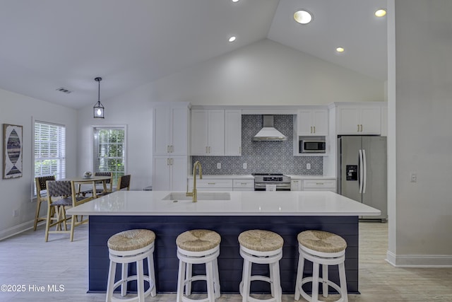 302 Gaskins Ln, Wilmington, NC 28411 - kitchen featuring stainless steel appliances, a sink, wall chimney exhaust hood, baseboards, and white cabinets