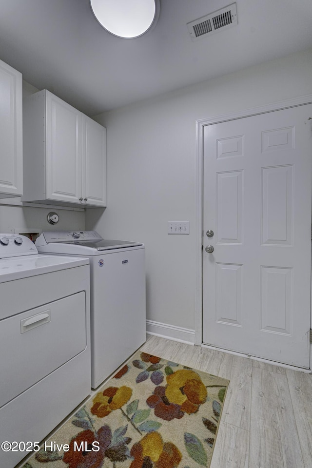302 Gaskins Ln, Wilmington, NC 28411 - laundry room featuring cabinet space, washer and dryer, light wood-style floors, and baseboards