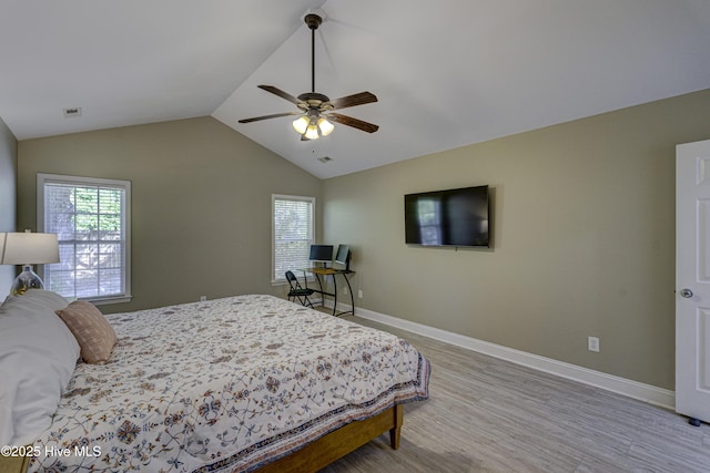 302 Gaskins Ln, Wilmington, NC 28411 - bedroom featuring multiple windows, lofted ceiling, wood finished floors, baseboards, and ceiling fan