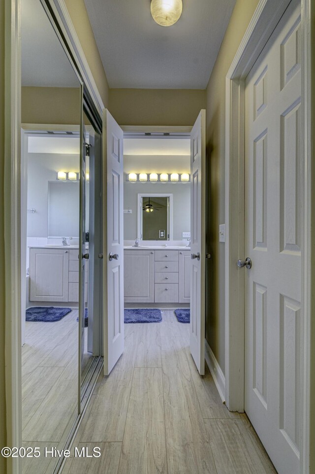 302 Gaskins Ln, Wilmington, NC 28411 - corridor with light wood-style flooring and a sink
