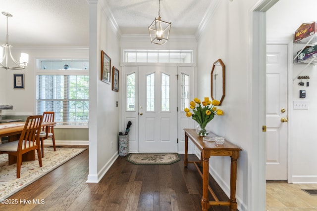 308 Crooked Gulley Cir, Sunset Beach, NC 28468 - entryway featuring a chandelier, crown molding, baseboards, and wood-type flooring