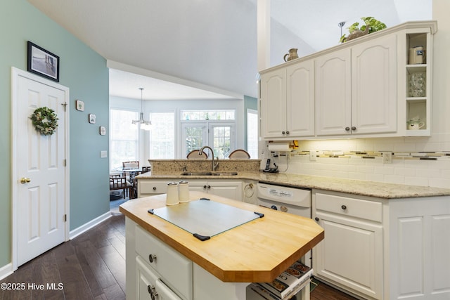 308 Crooked Gulley Cir, Sunset Beach, NC 28468 - kitchen with a sink, wooden counters, tasteful backsplash, a peninsula, and white cabinets